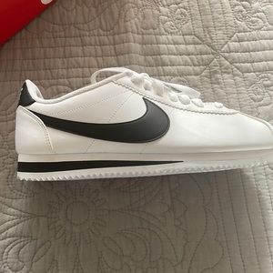 New in box, “Women’s size 10 Classic Cortez Leather shoes white/black”